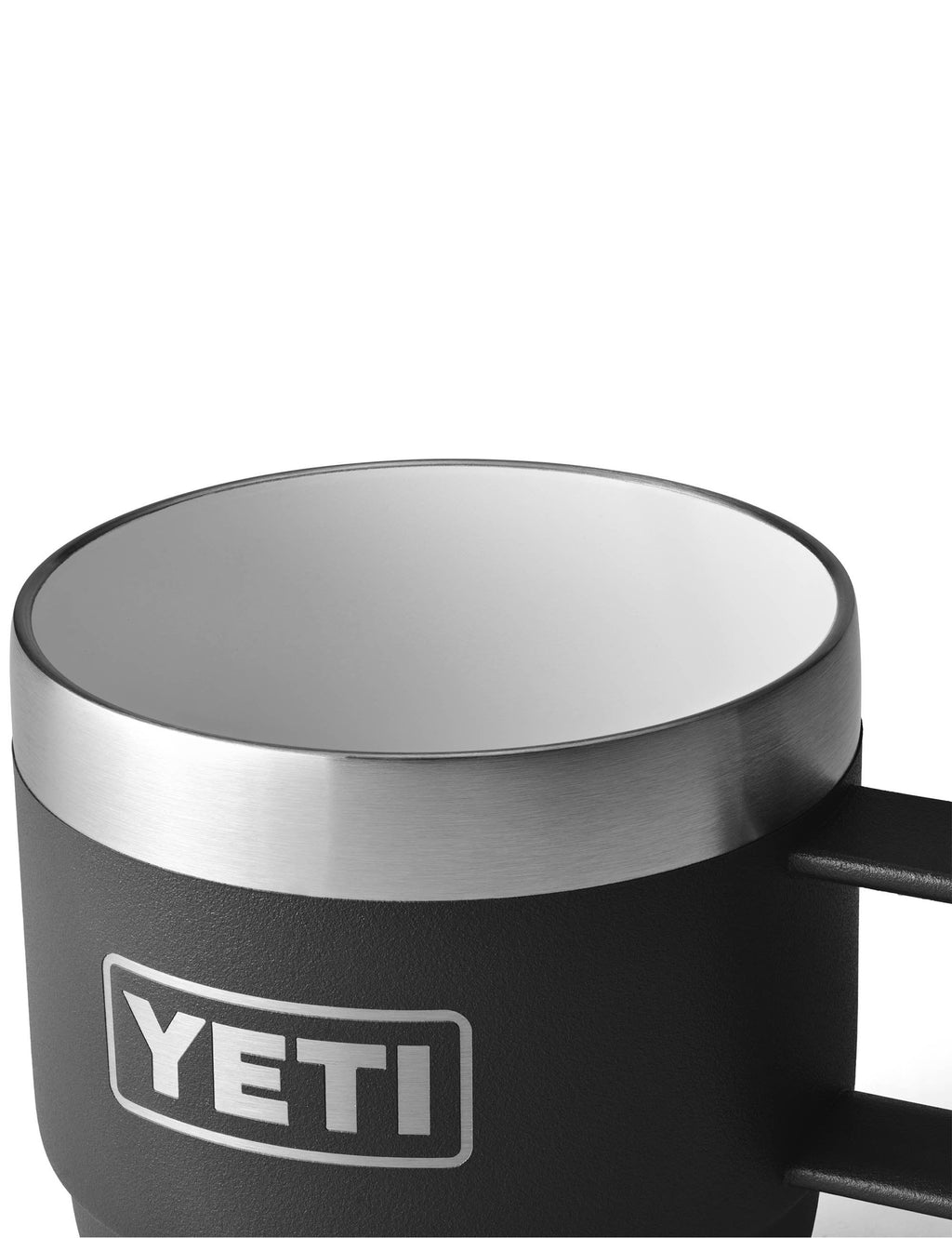 Close-up black espresso mug top and handle, silver rim, with YETI logo