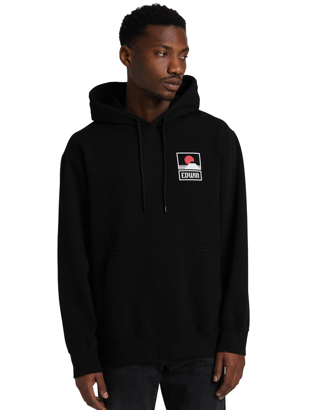 Black hooded sweatshirt on model with chest logo patch and drawstring hood