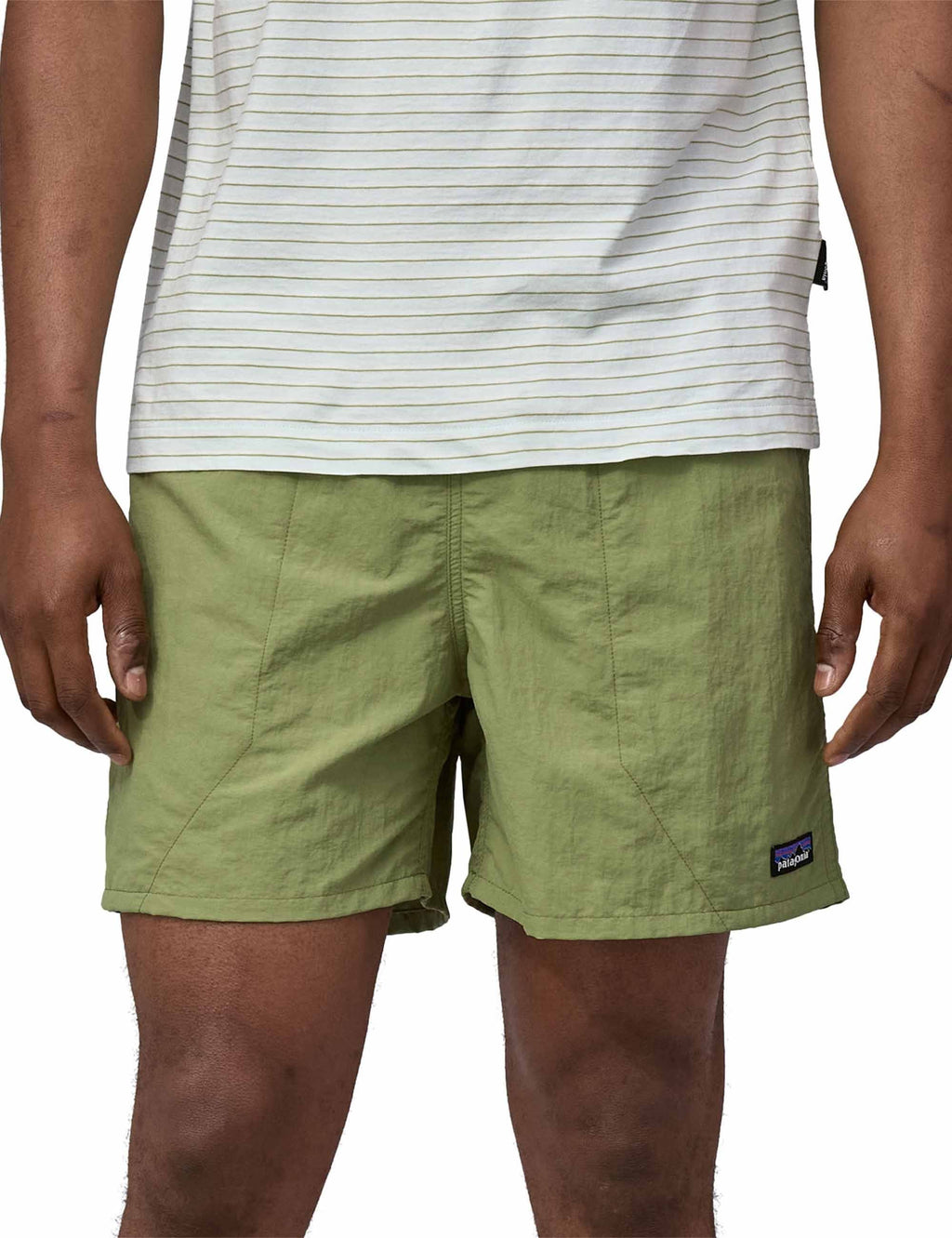 Green casual shorts with elastic waist, side pockets, and small logo patch