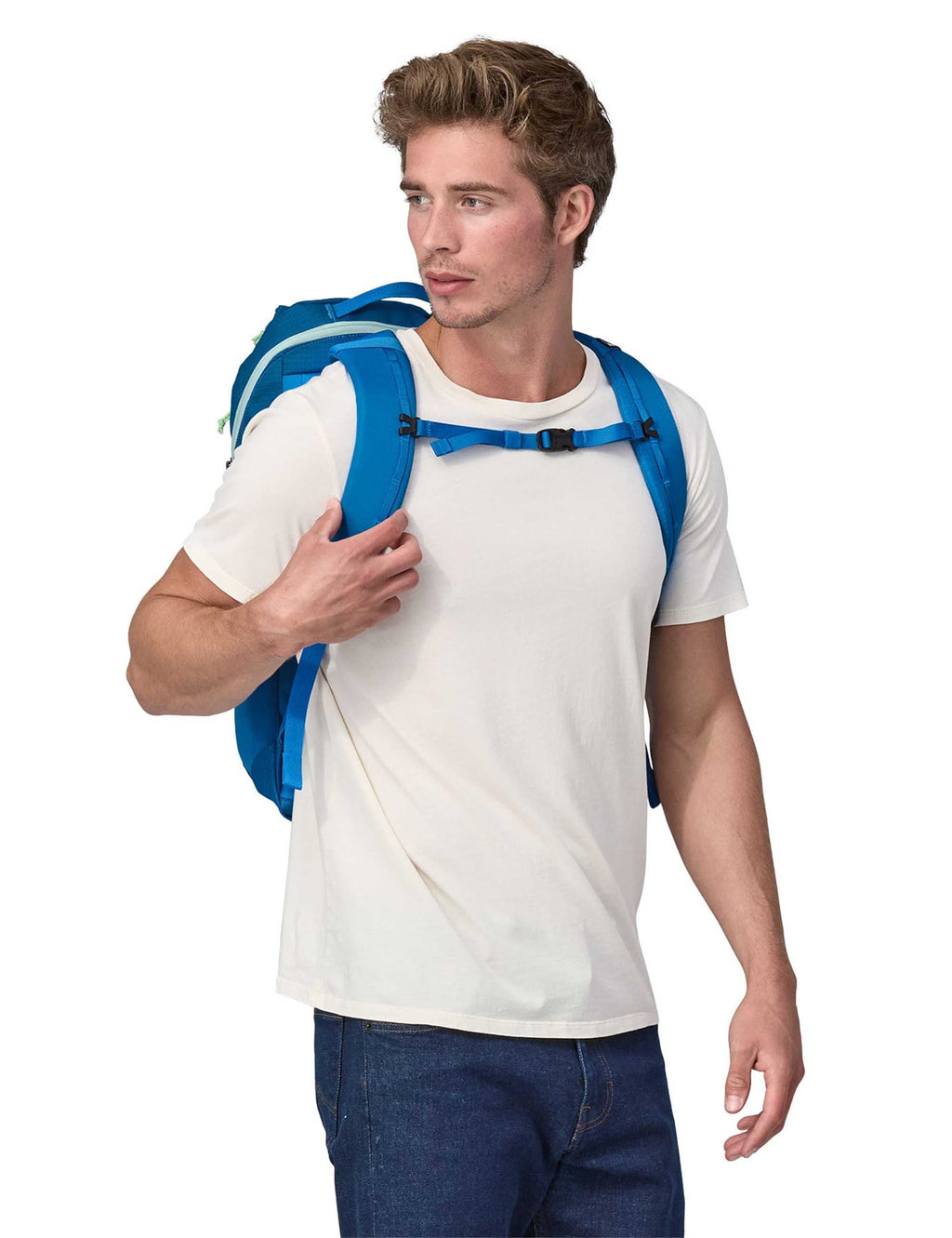 Vessel Blue 25L backpack front view on model, padded shoulder straps
