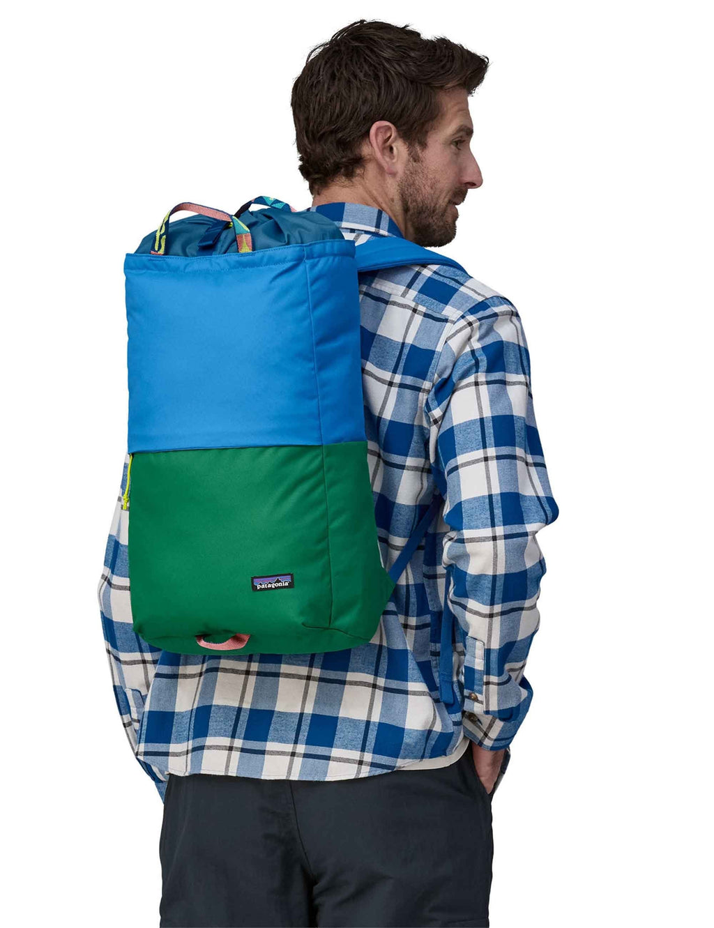 Linked backpack in blue and green, worn back, with yellow drawstring and side pocket