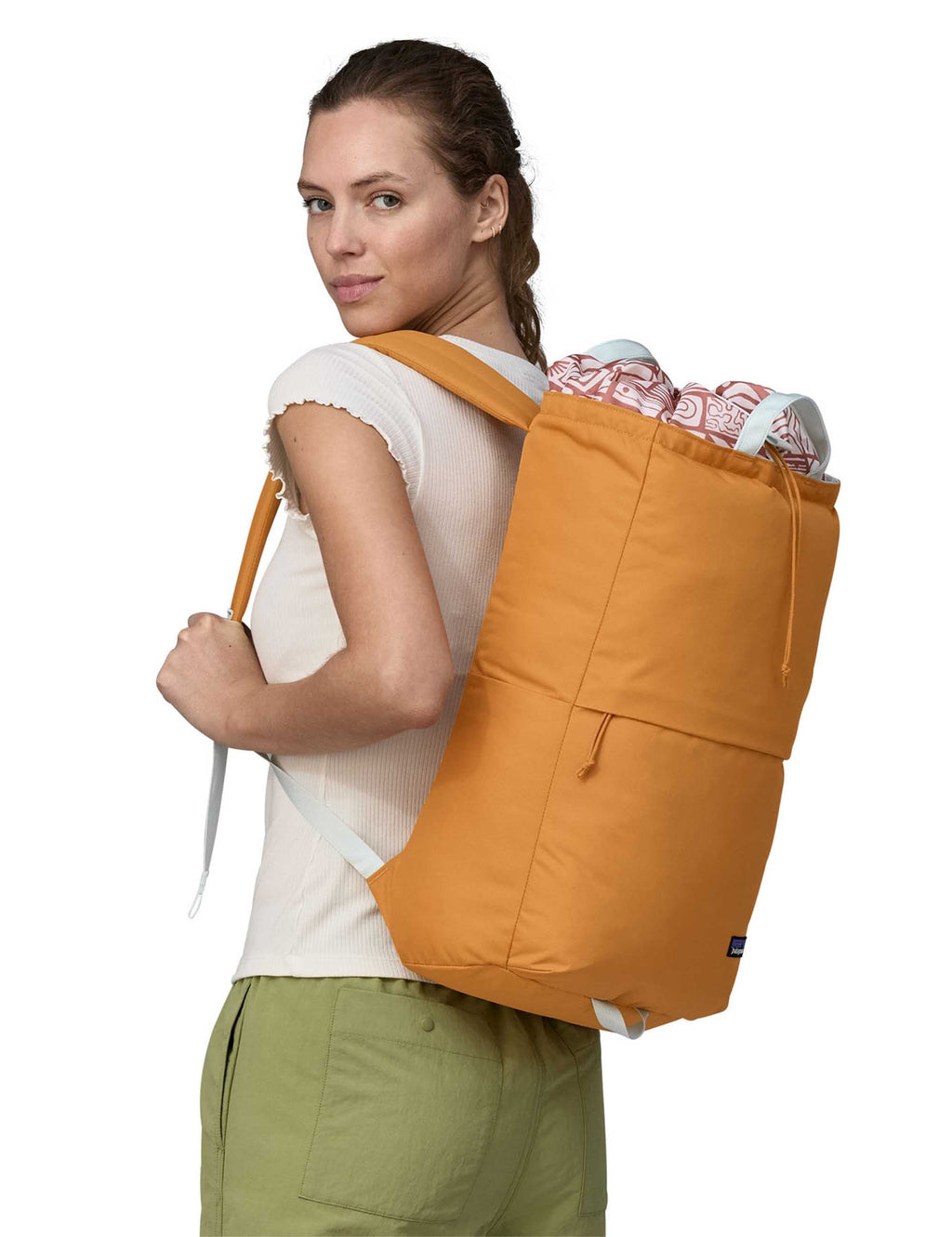Golden caramel 25L backpack with shoulder straps, worn on back
