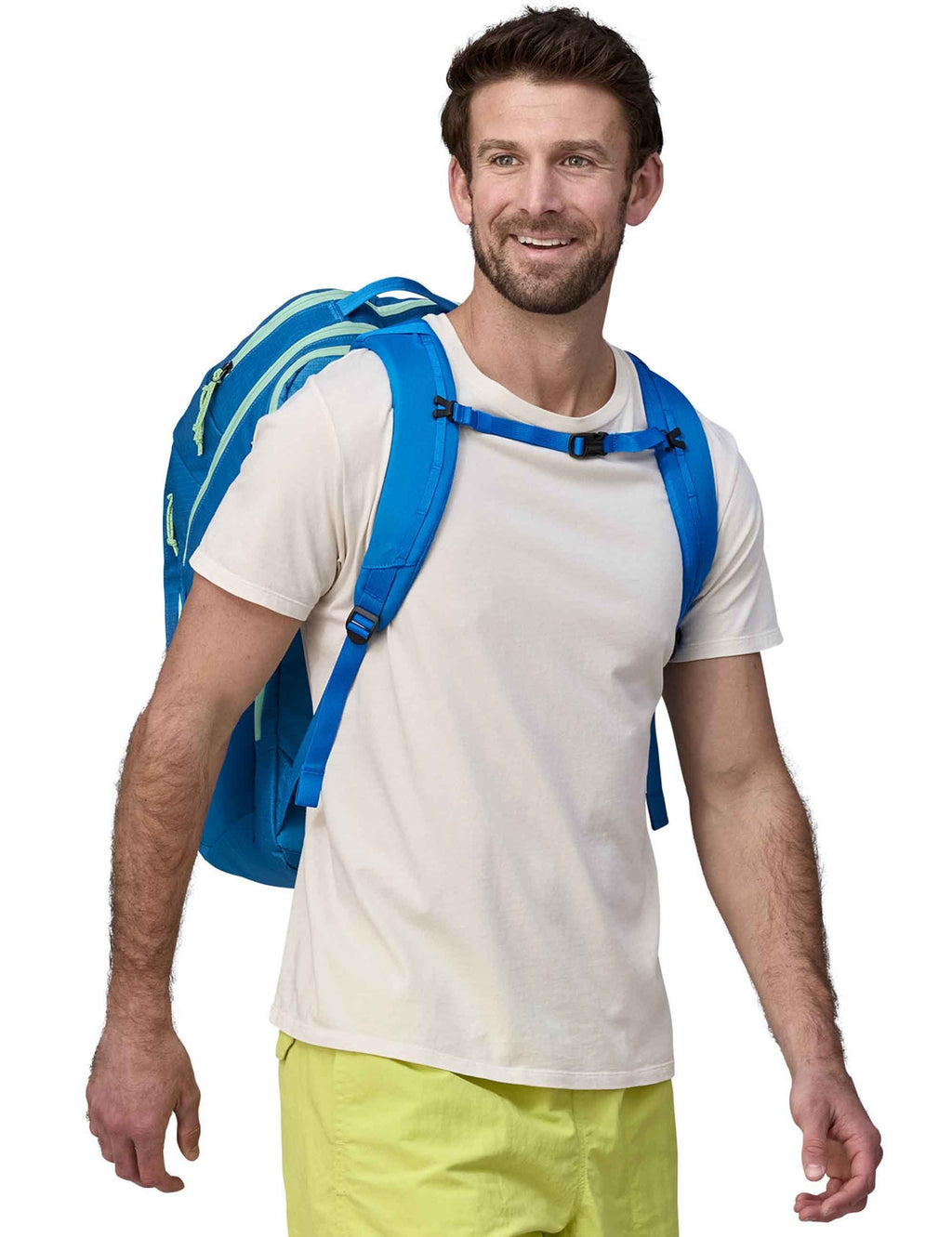 32L backpack on model, blue with front pocket and multiple adjustable straps