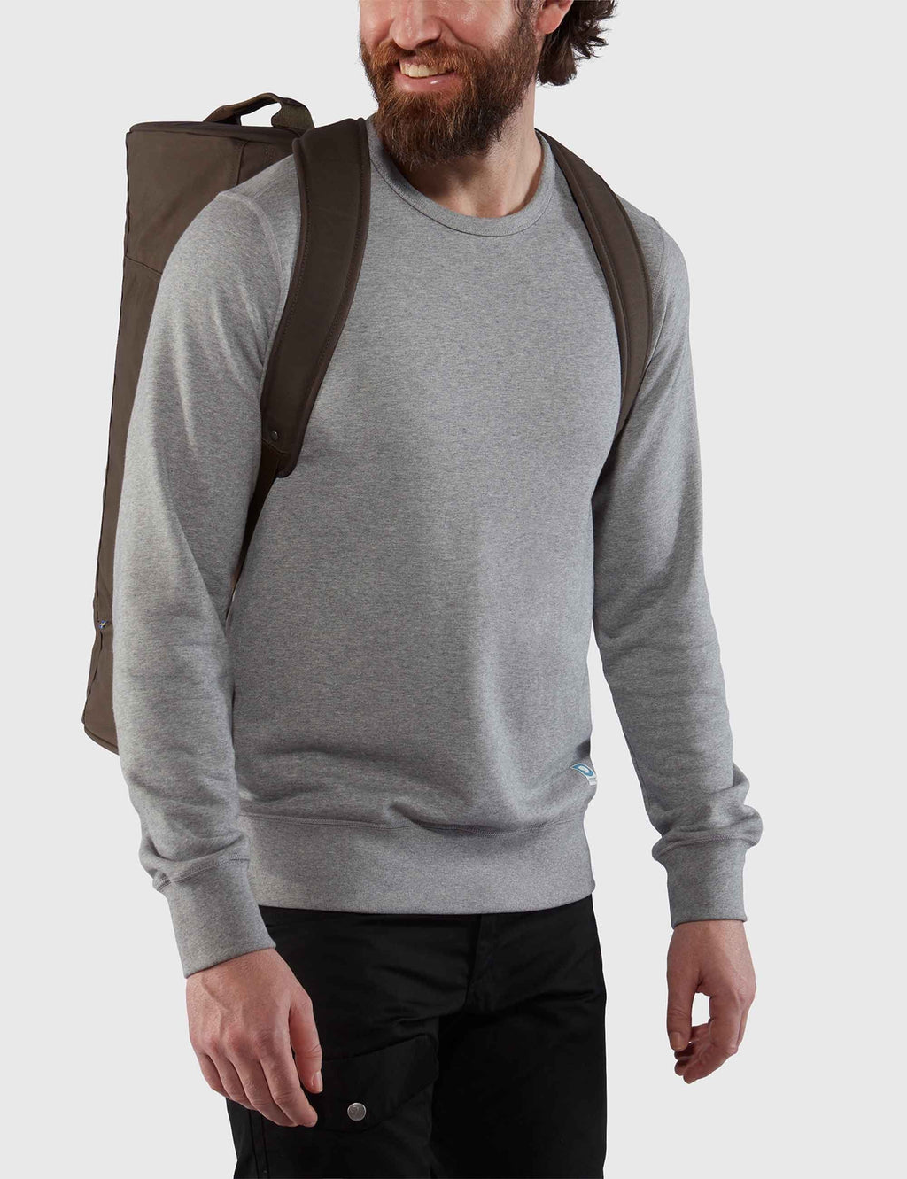 Dark olive travel bag worn on shoulders with back panel and shoulder straps.