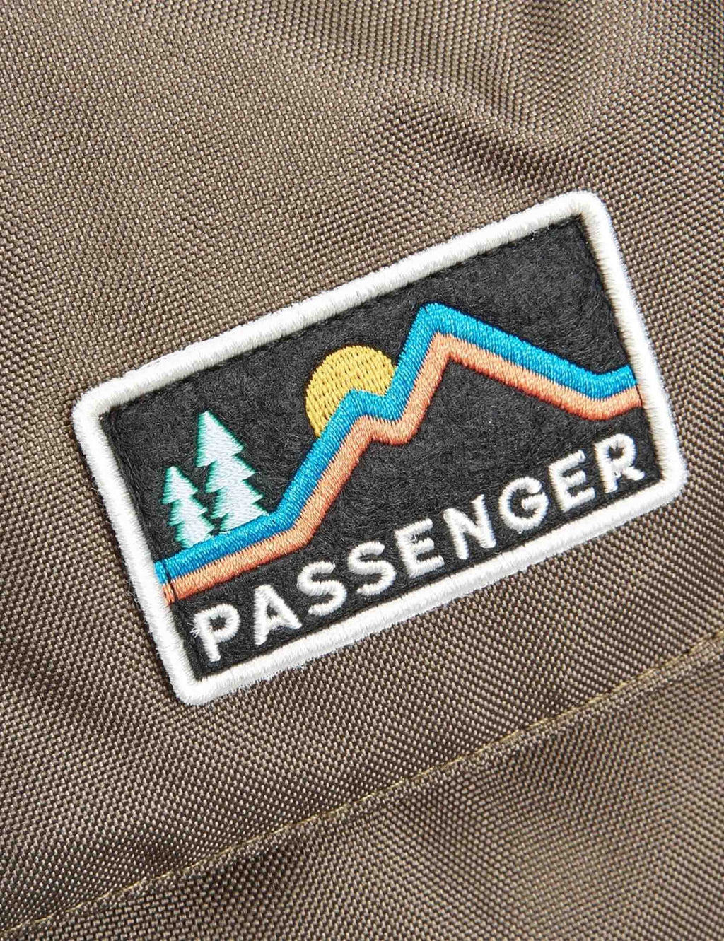 Logo patch on recycled backpack fabric, with mountains and PASSENGER text