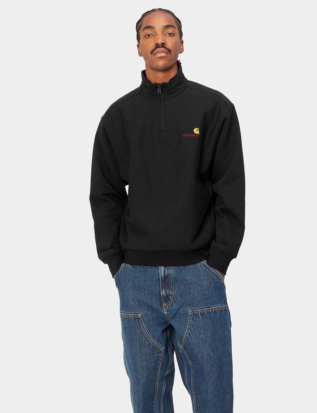 Black half-zip sweatshirt with chest logo, worn with a high collar