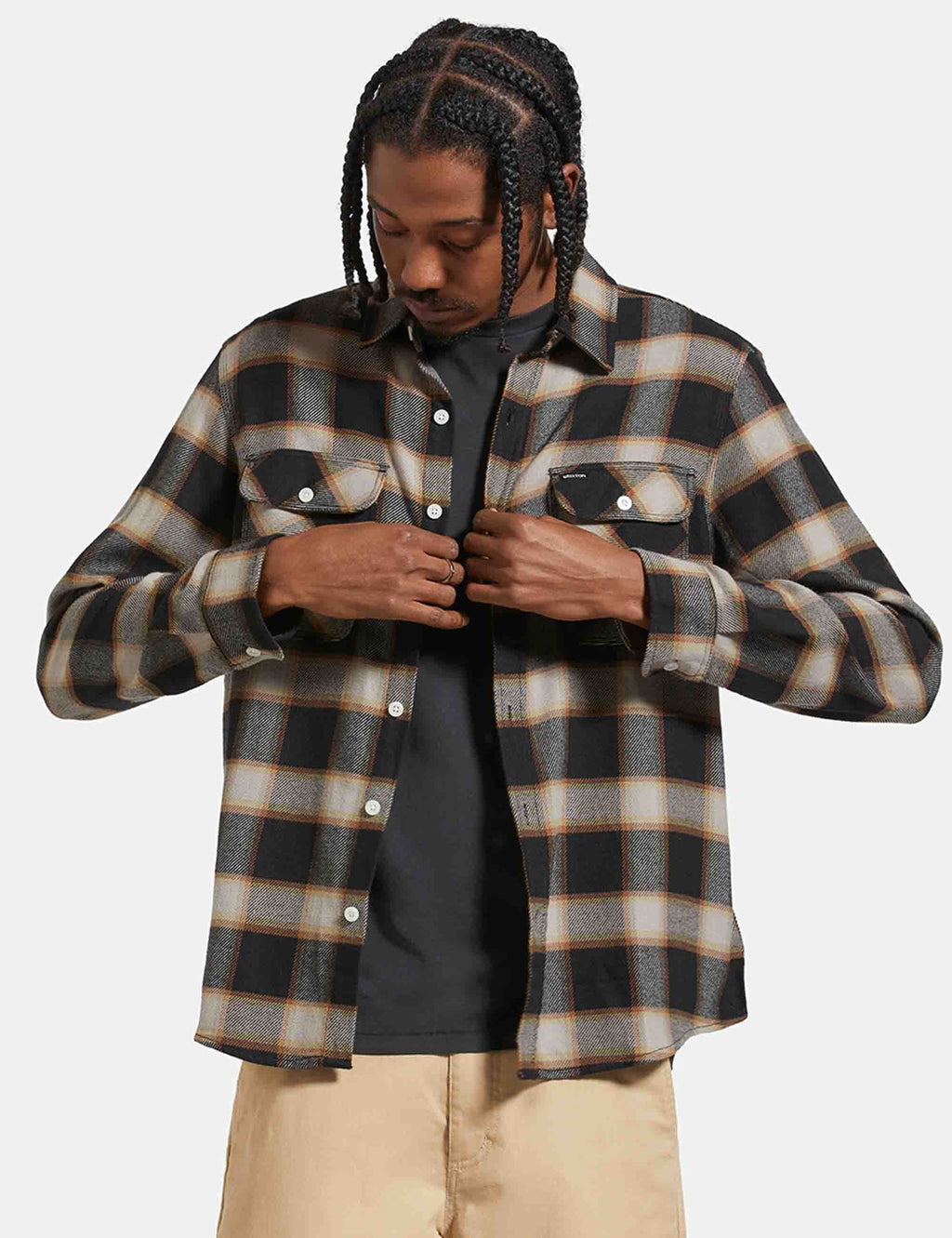 Black and cream plaid flannel shirt with snap buttons, chest pockets, open collar.