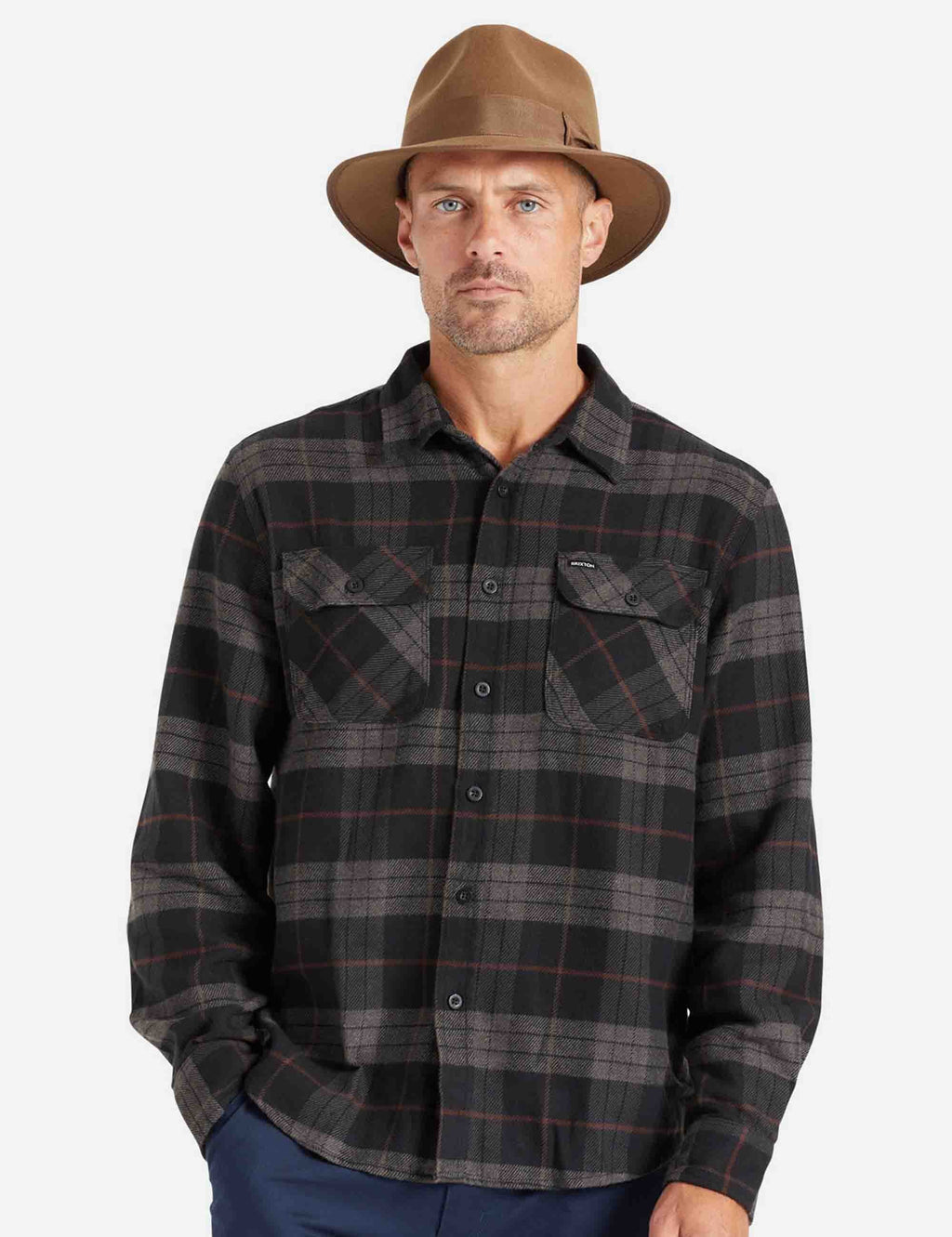 Dark plaid flannel shirt on model with button-down collar and chest pockets