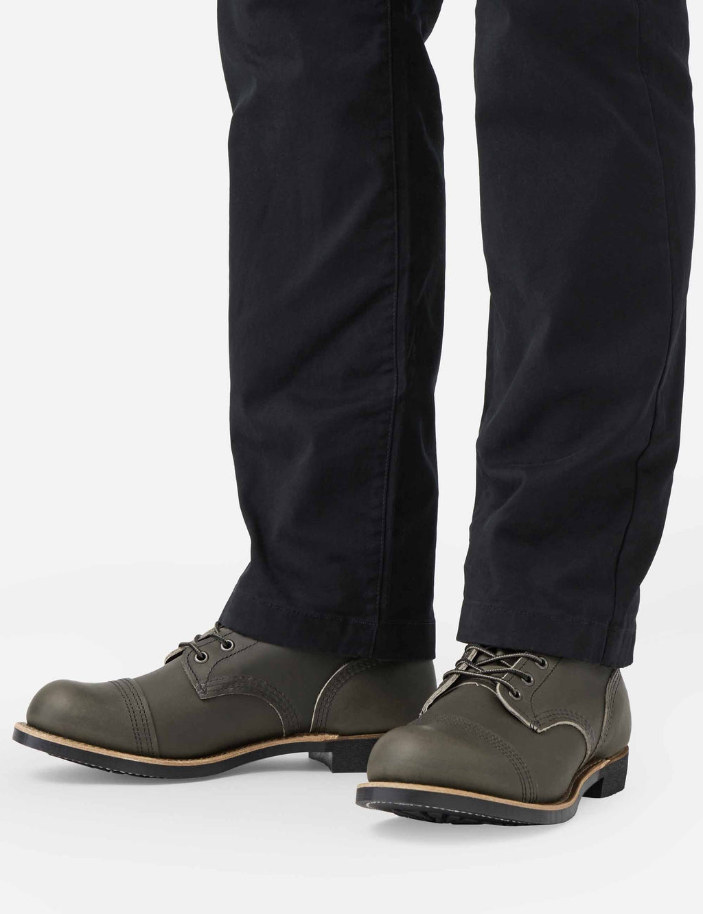 Dark brown lace-up boots worn with dark pants; thick sole and lace-up front