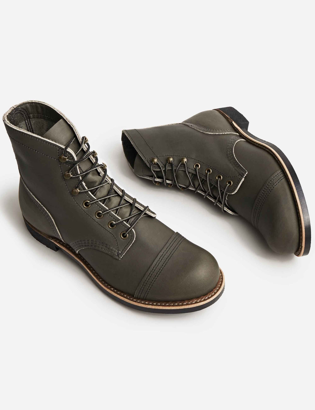 Pair of dark brown lace-up work boots with brogue-style panels and rugged outsole