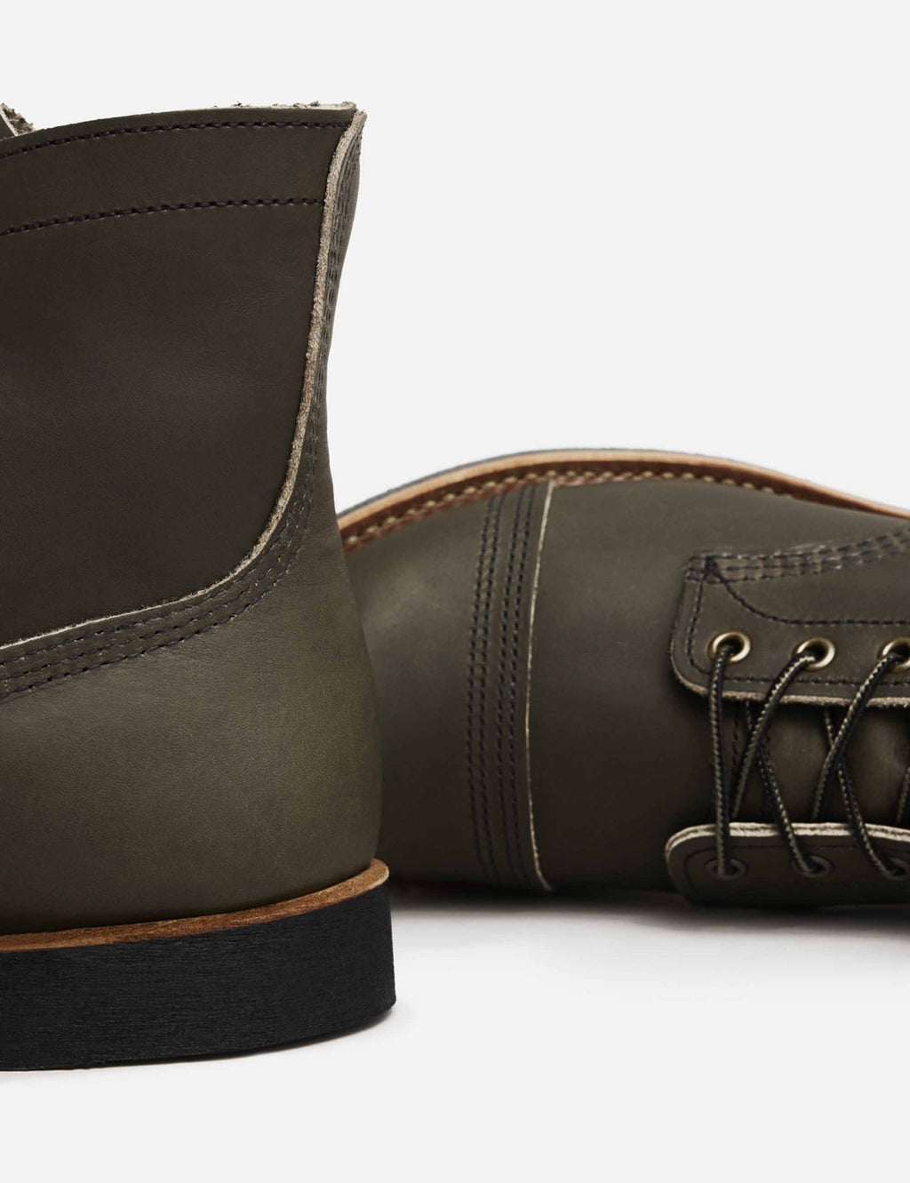 Dark brown boot shaft with visible stitching and black outsole edge