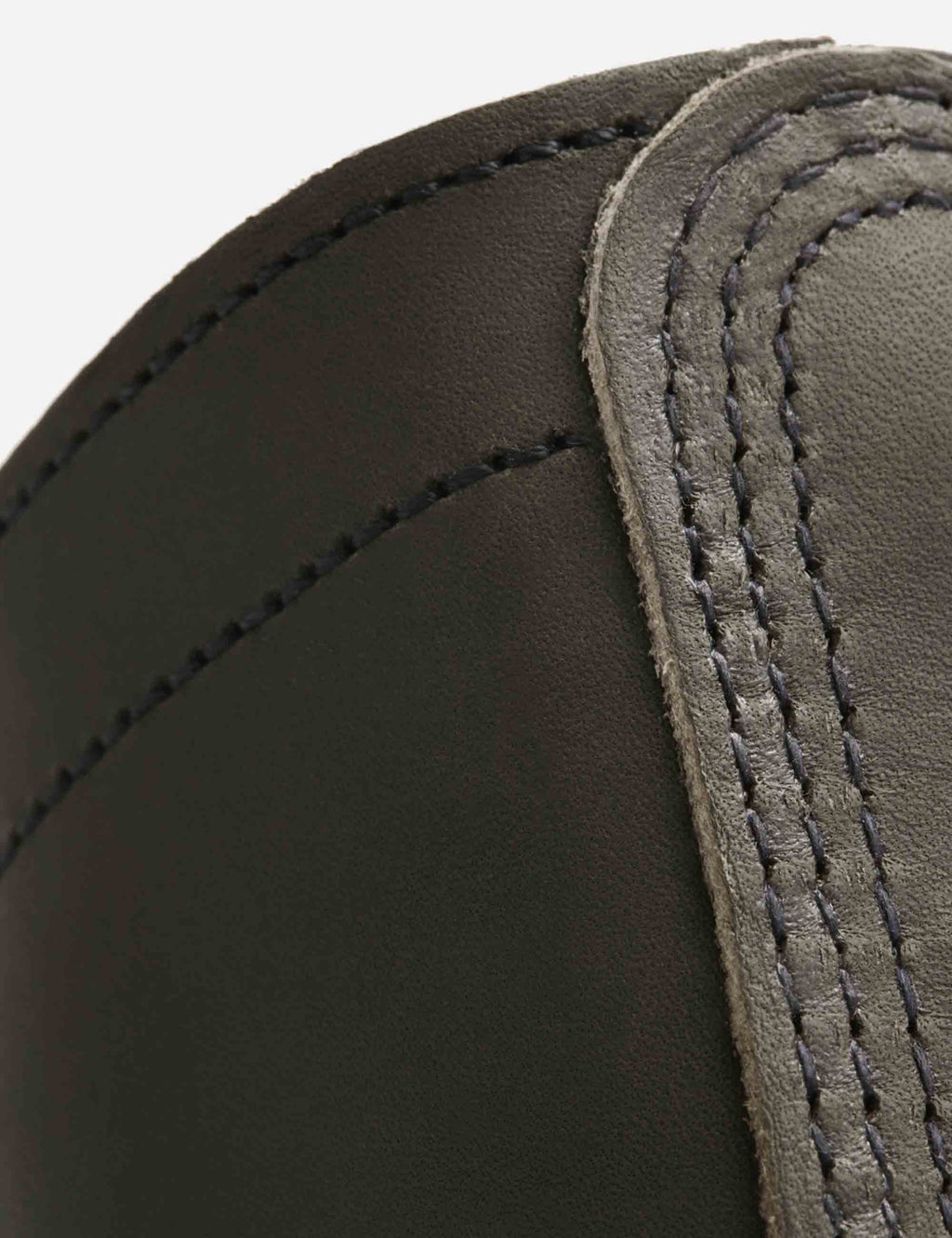 Close-up of dark brown leather boot quarter with contrast seam stitching
