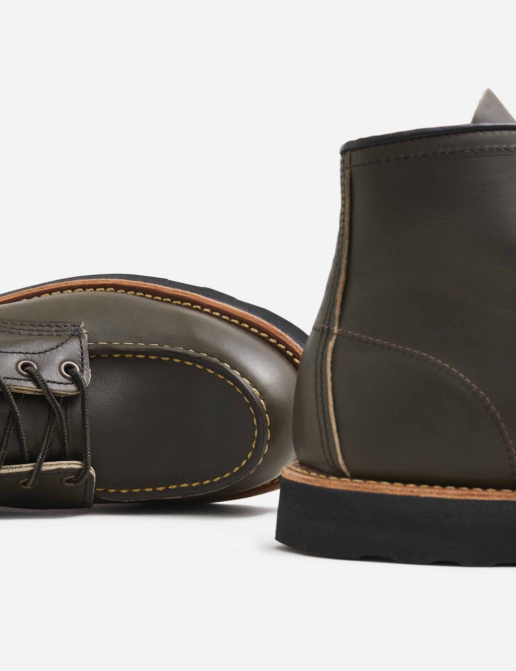 Dark olive leather moc-toe boot toe and heel with tan edge stitching