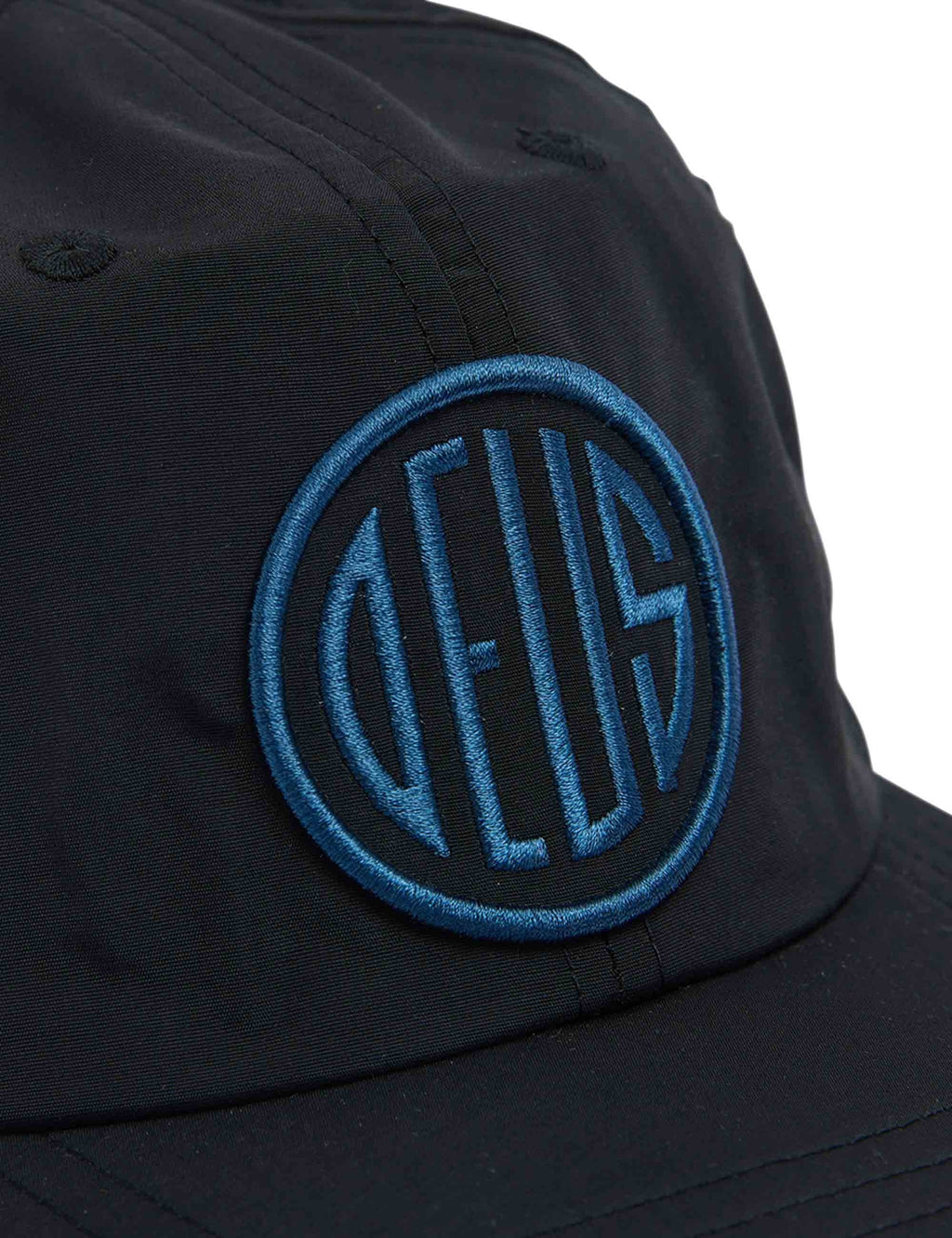 Black baseball cap close-up with blue circular emblem logo
