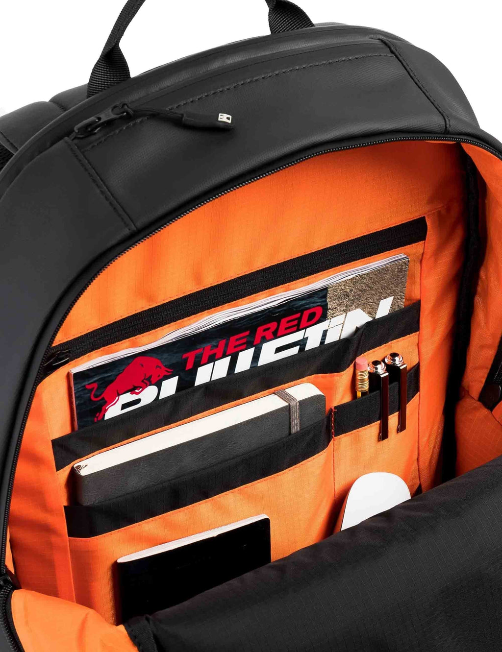 All-black backpack open to show bright orange interior organizer and zip compartments