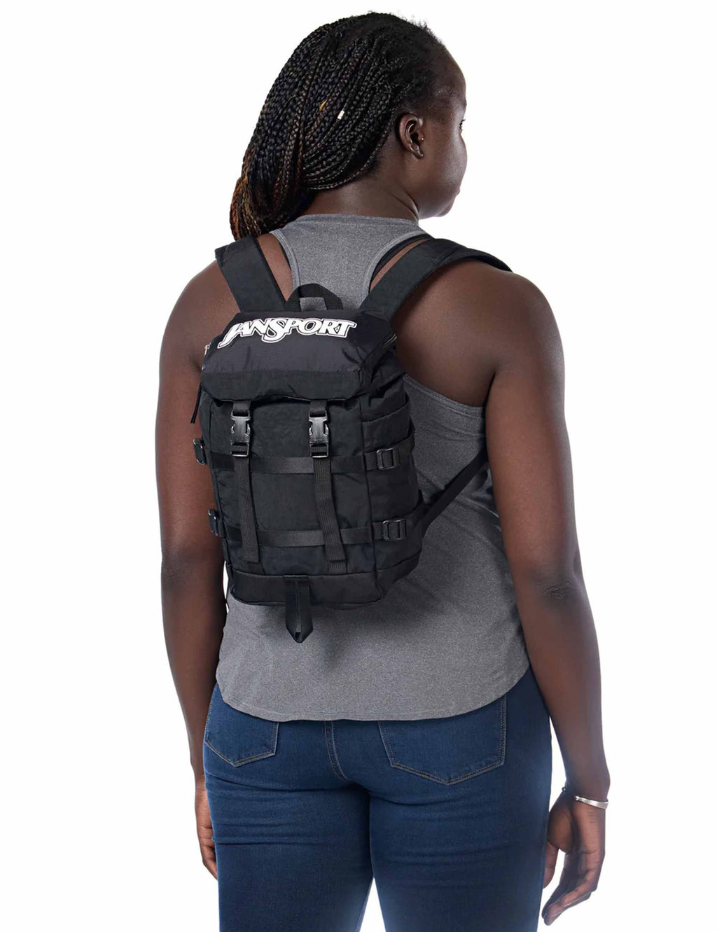 Mini backpack worn by person from back, with Jansport logo and shoulder straps