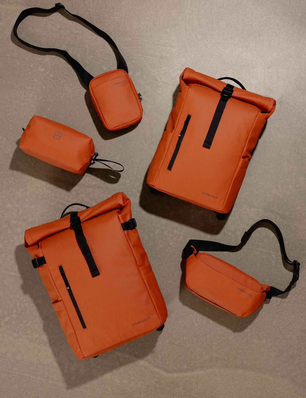 Rust roll-top backpack with matching pouches and crossbody strap