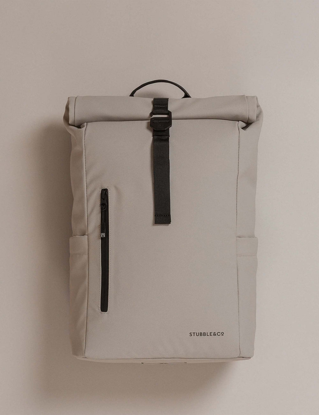 Sand roll-top backpack front view with roll-top closure and vertical zip pocket