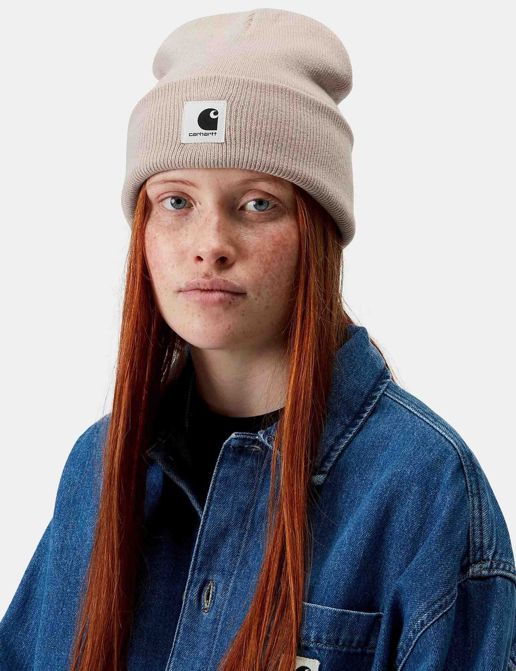 Light beige knit beanie on model, ribbed cuff and Carhartt logo patch