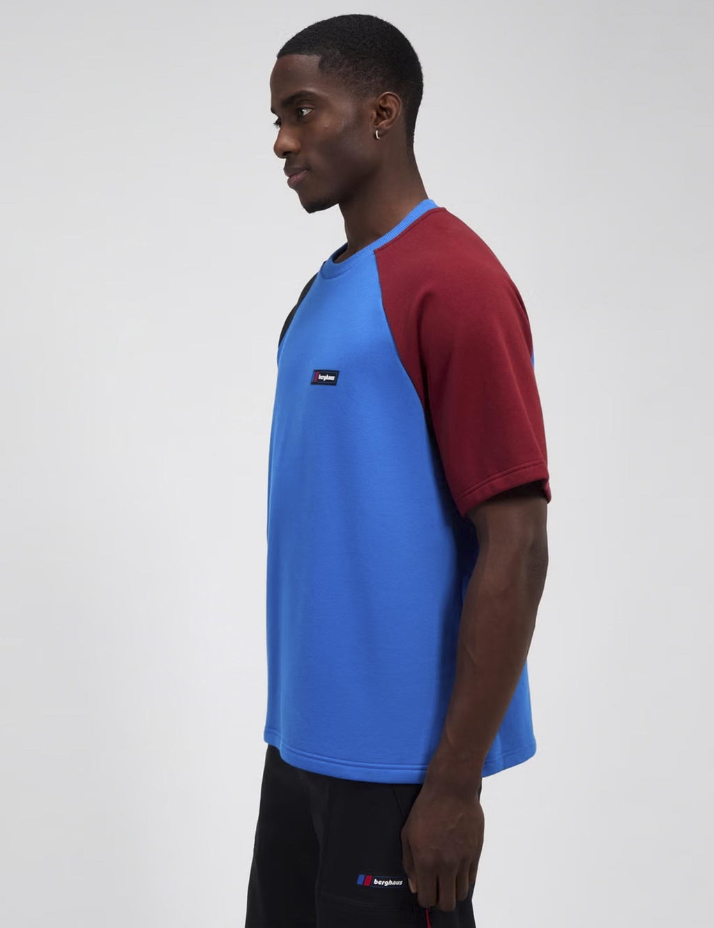 Raglan T-shirt side profile, light blue body with burgundy sleeves and black trim