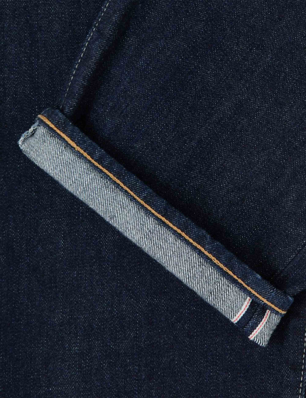 Selvedge denim hem with light gray lining and orange stitch on cuff