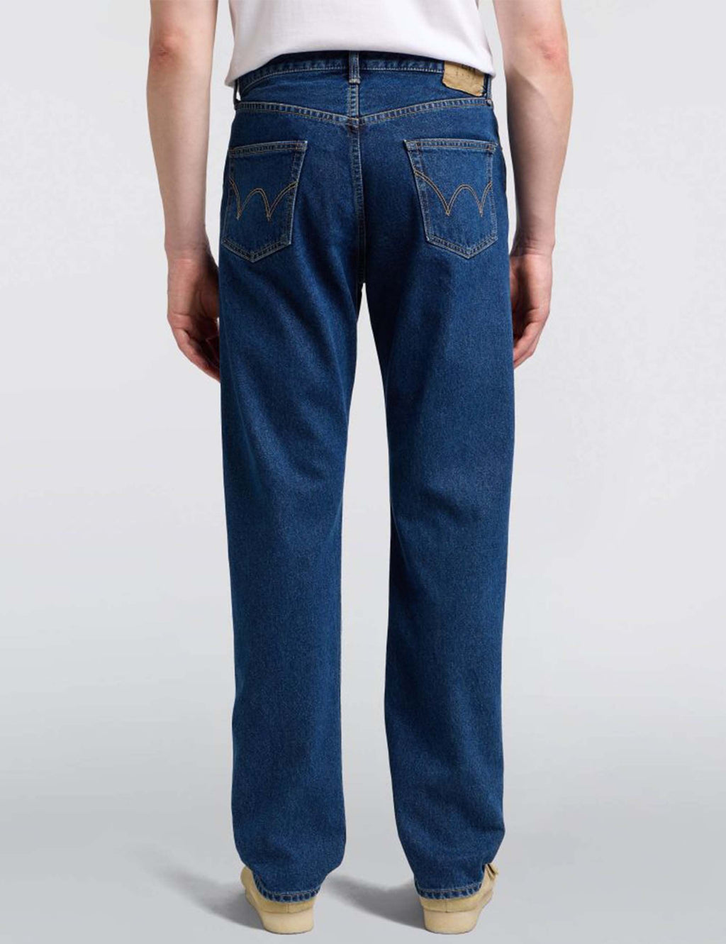 Mid-wash blue straight jeans with embroidered rear pockets and relaxed fit