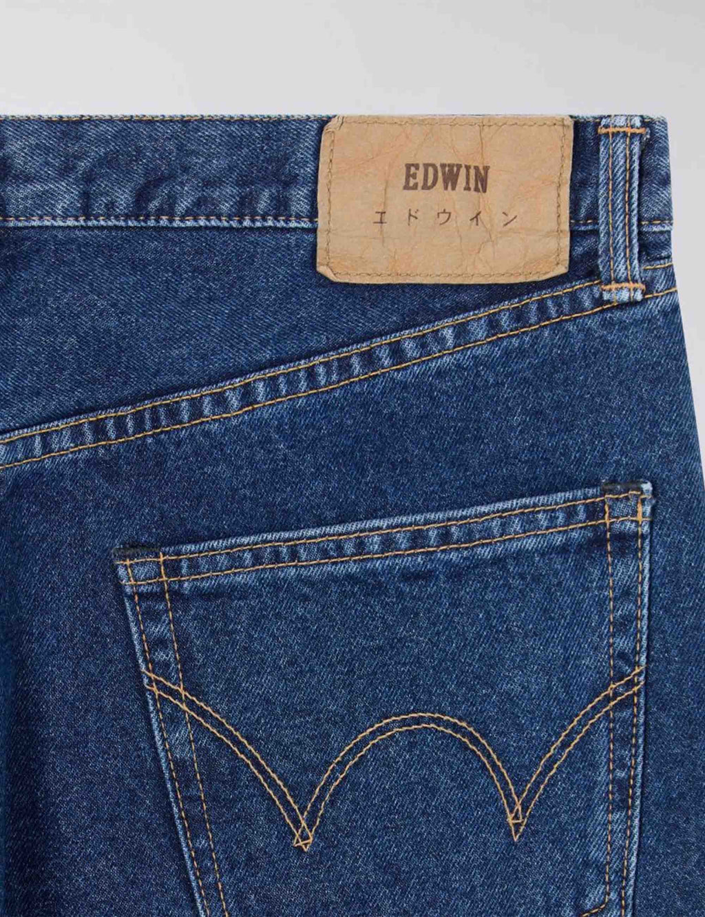 Mid-wash blue jeans, logo patch and stitched rear pocket outline