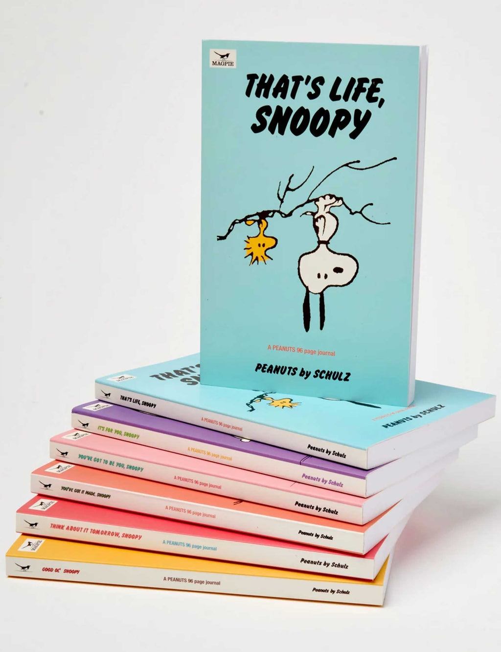 Stack of Snoopy journals with light blue covers and titled spines