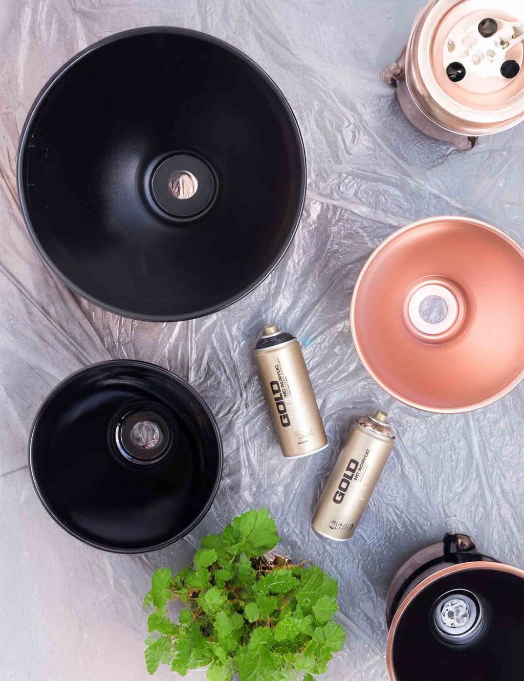 Copper chrome spray paint can set with caps, shown among other spray cans and cups