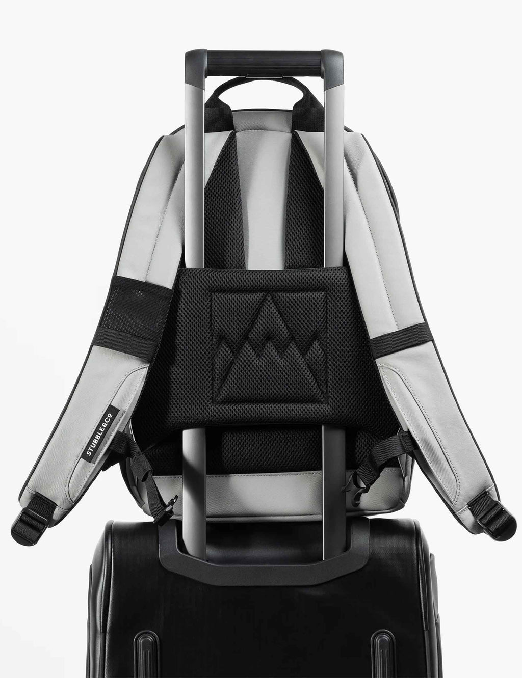 Light gray backpack back view with black mesh panel and padded shoulder straps