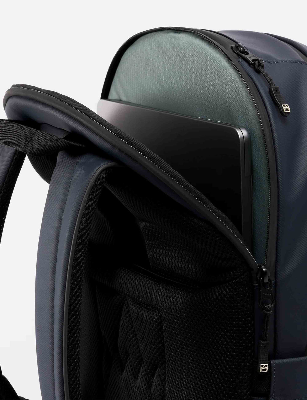 Midnight blue backpack interior with greenish lining and zippered mesh pocket