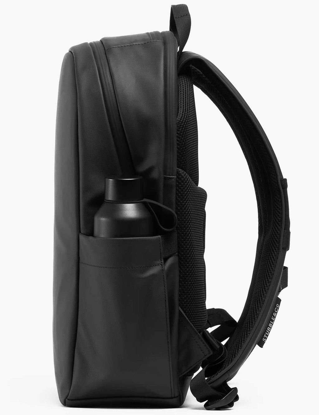 All-black backpack side profile with bottle pocket and curved top handle