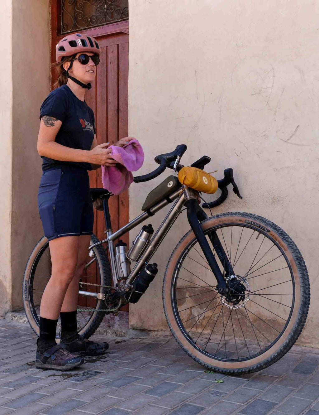 Black handlebar pocket bag on bicycle handlebar, webbing straps and zip closure.