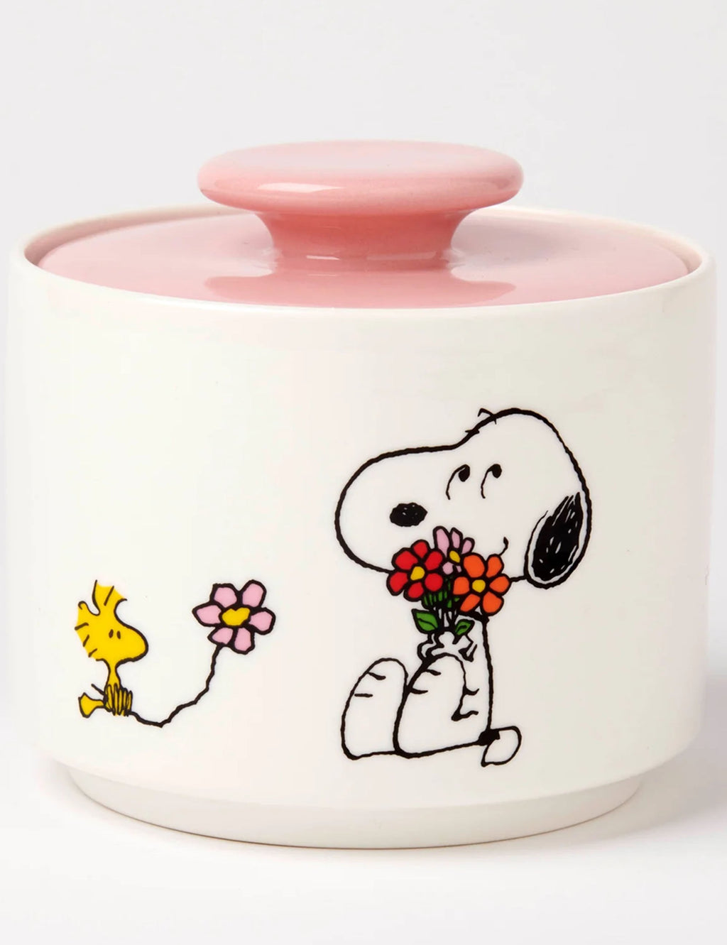 White ceramic candy jar with pink lid, Snoopy holding a bouquet and small flower icons