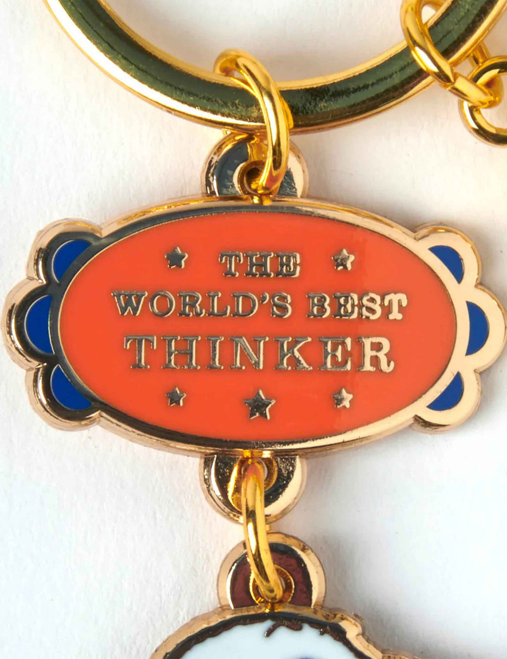 Snoopy keychain oval badge reading THE WORLD'S BEST THINKER