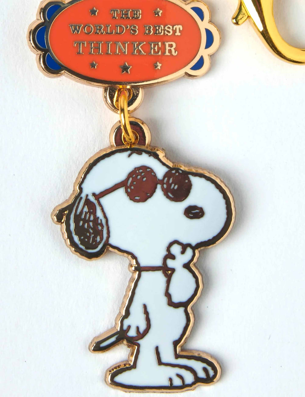 Snoopy keychain with seated Snoopy figure and THE WORLD'S BEST THINKER badge