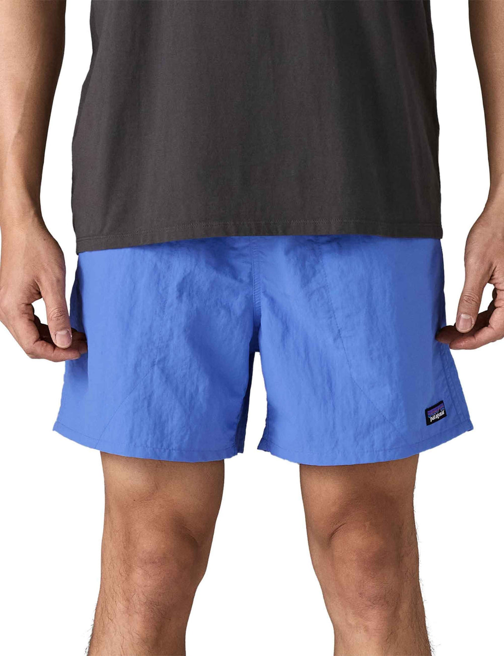 Blue shorts with elastic waistband, side seams, and logo label near right hem.