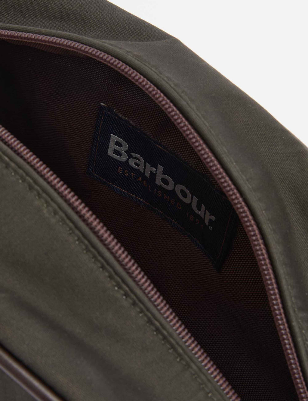 Wax wash bag interior label with Barbour branding and maroon zipper