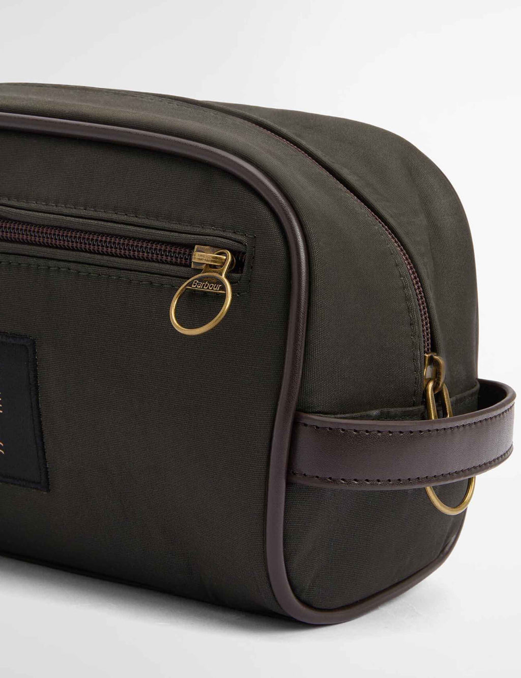 Wax wash bag angled side with gold-tone zipper pull and stitched trim