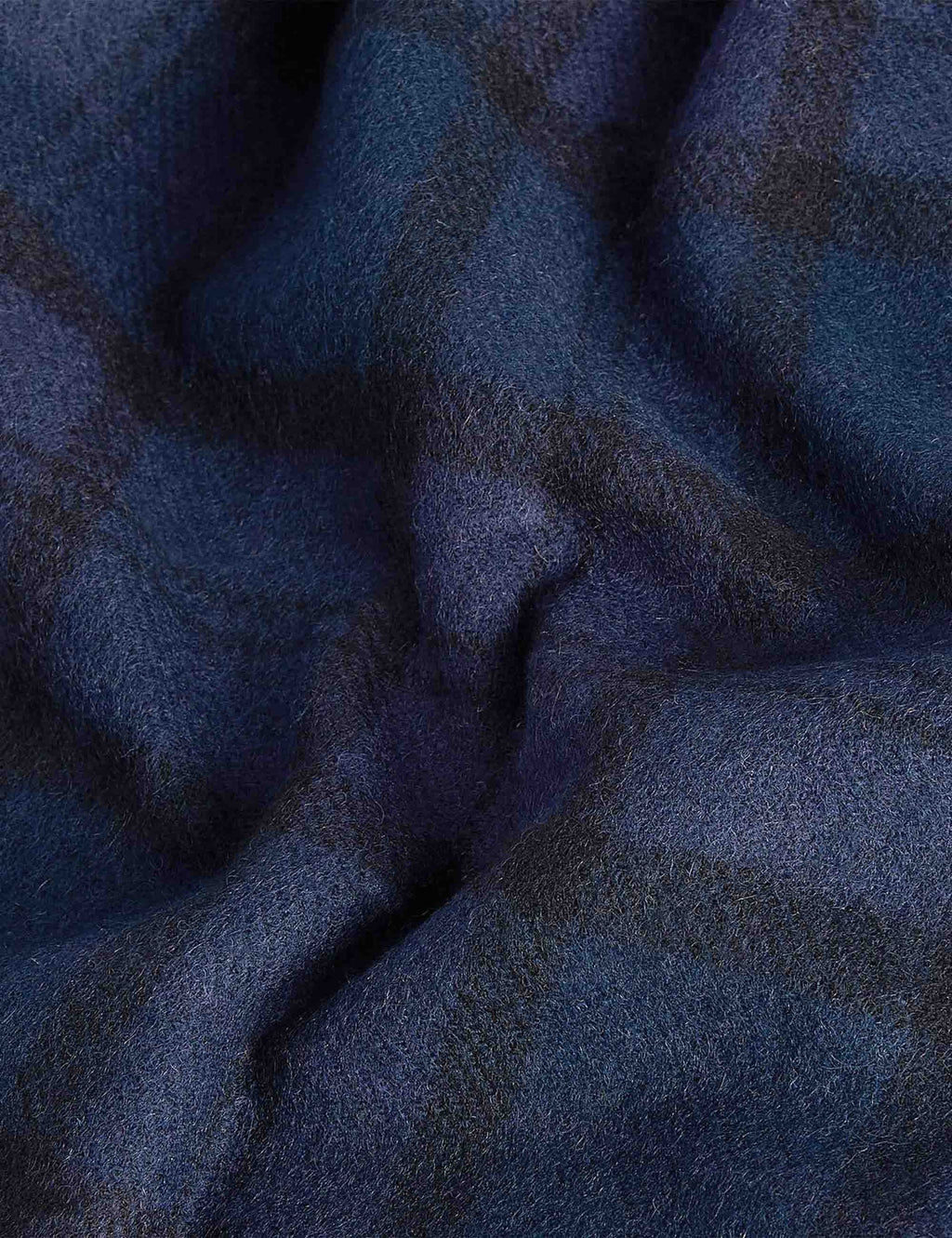 Black Watch tartan lambswool scarf fabric close-up with woven plaid pattern