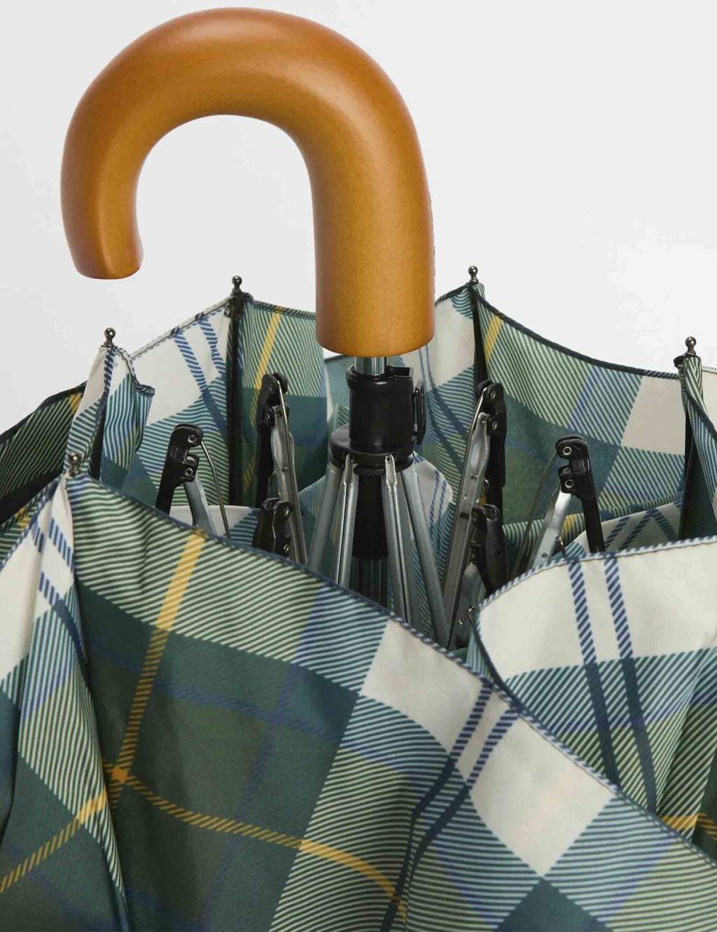 Open tartan mini umbrella with tan handle and dark green plaid fabric panels