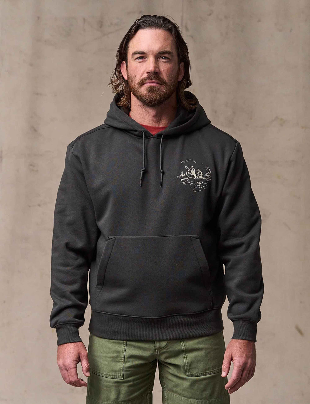 Faded black pullover hoodie with small chest graphic and drawstring hood
