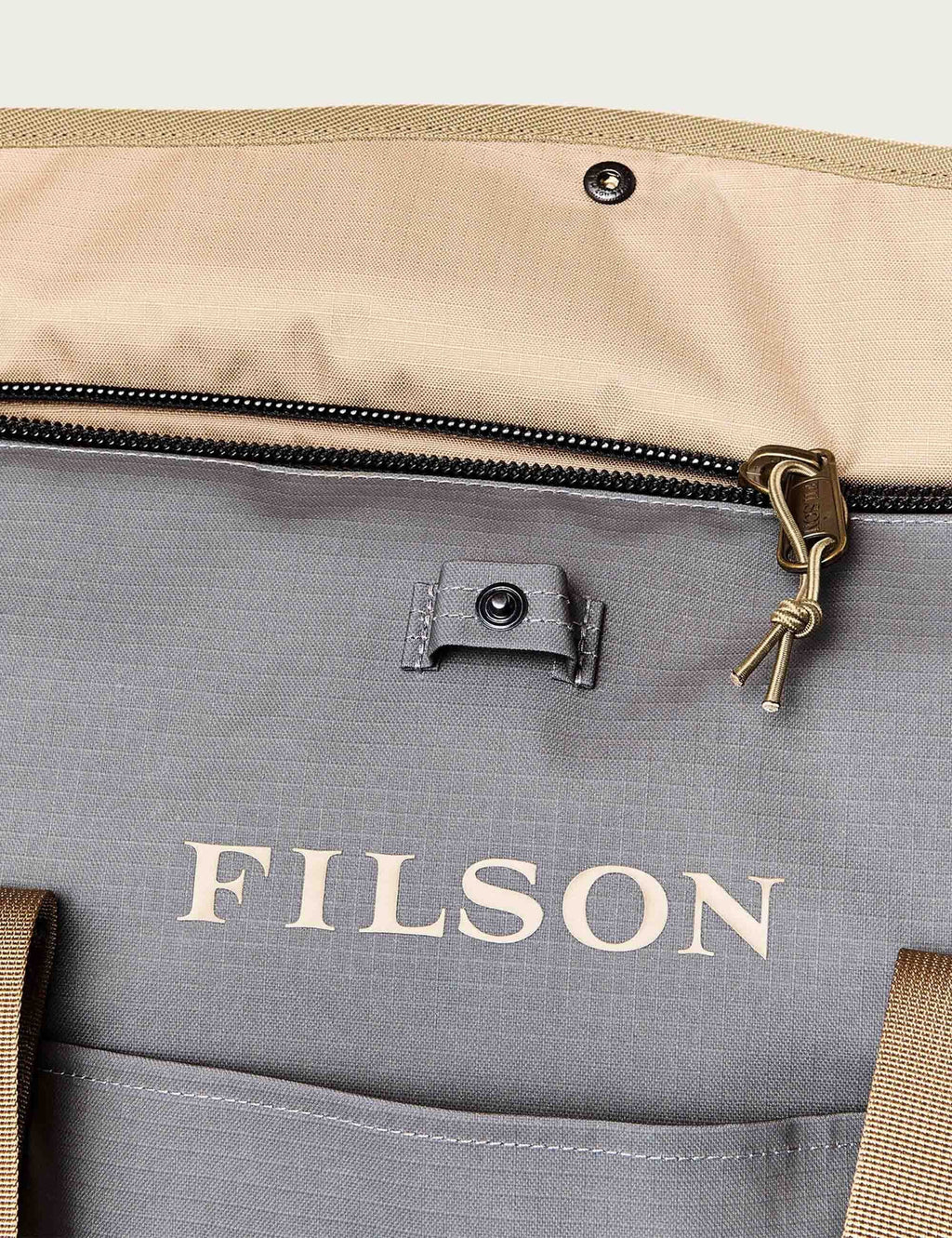 All-weather tote bag front pocket with FILSON logo and zipper pull, moon mist gray