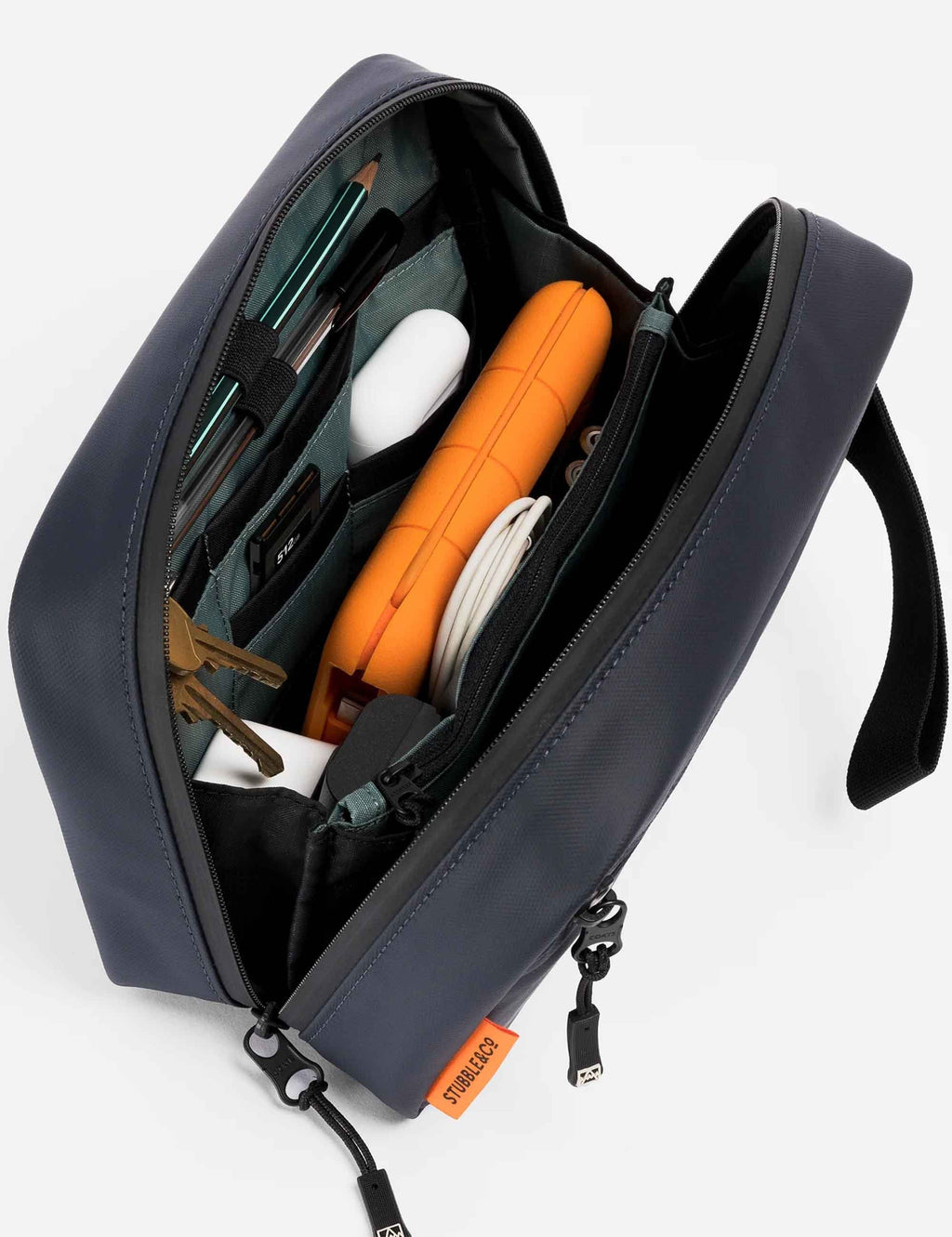 Midnight blue tech bag open with multiple pockets and orange insert