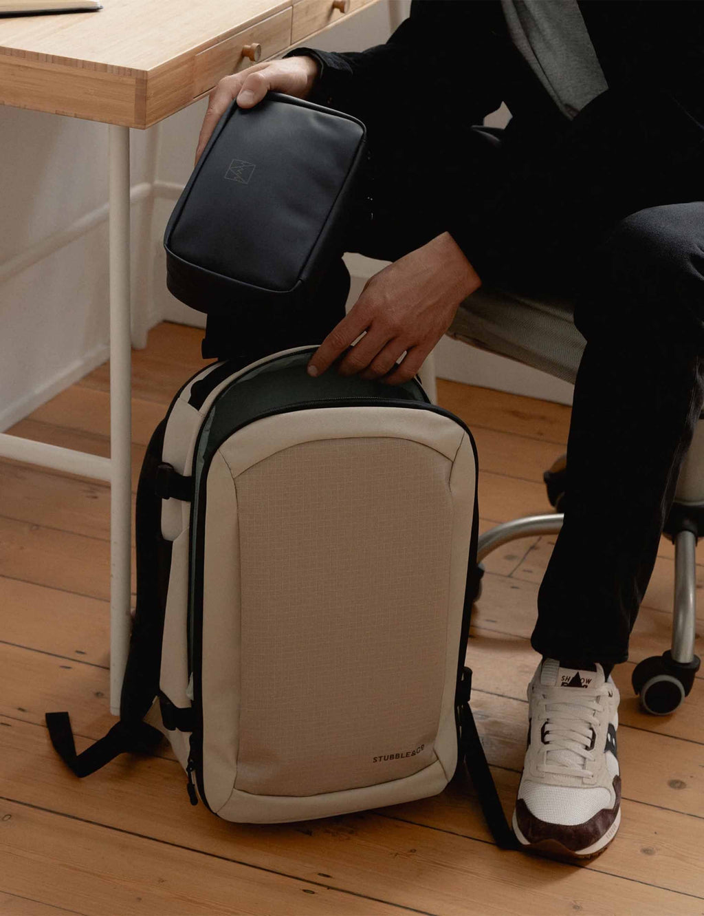 Midnight blue tech bag carried on a strap with zippered top