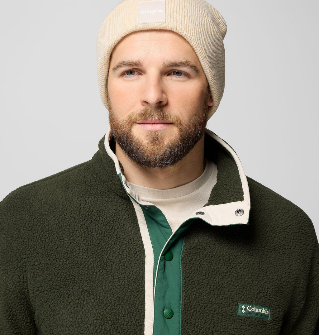 Men's dark green fleece pullover close-up of half-snap placket and Columbia logo