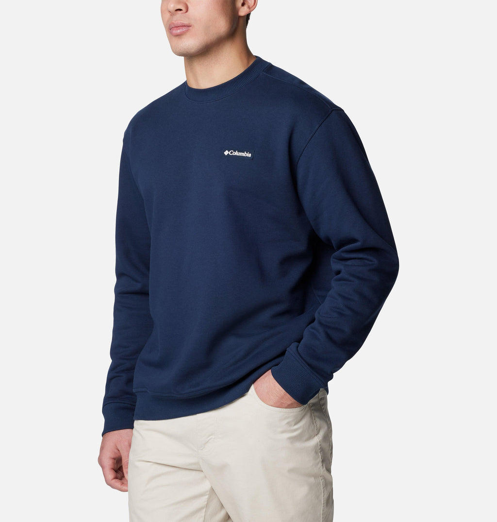Columbia navy crewneck sweatshirt with long sleeves and ribbed cuffs, model wearing it