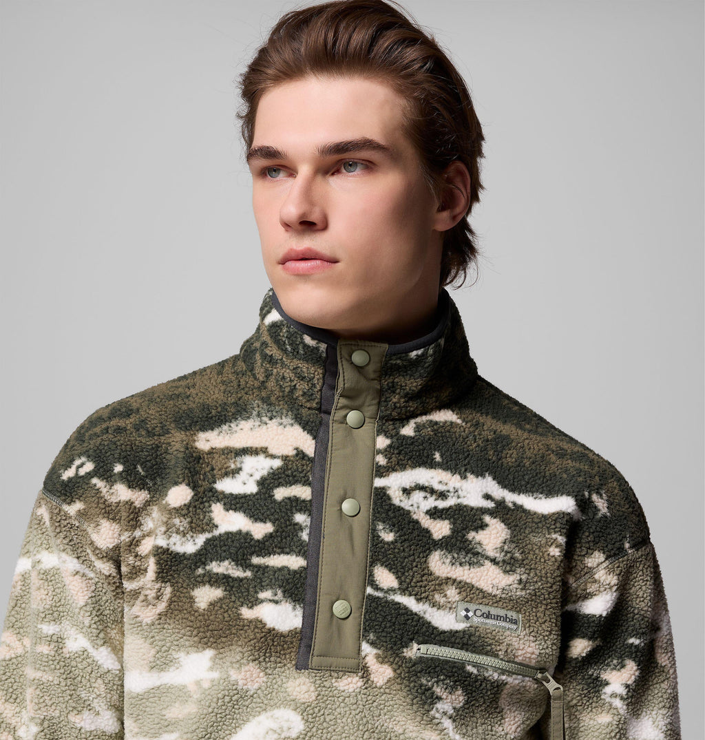 Close-up of khaki fleece pullover: olive nylon half-snap placket, stand collar, Columbia patch, sherpa pile