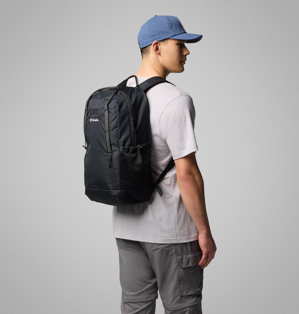 Black 25L backpack, side view with mesh pocket and adjustable shoulder straps