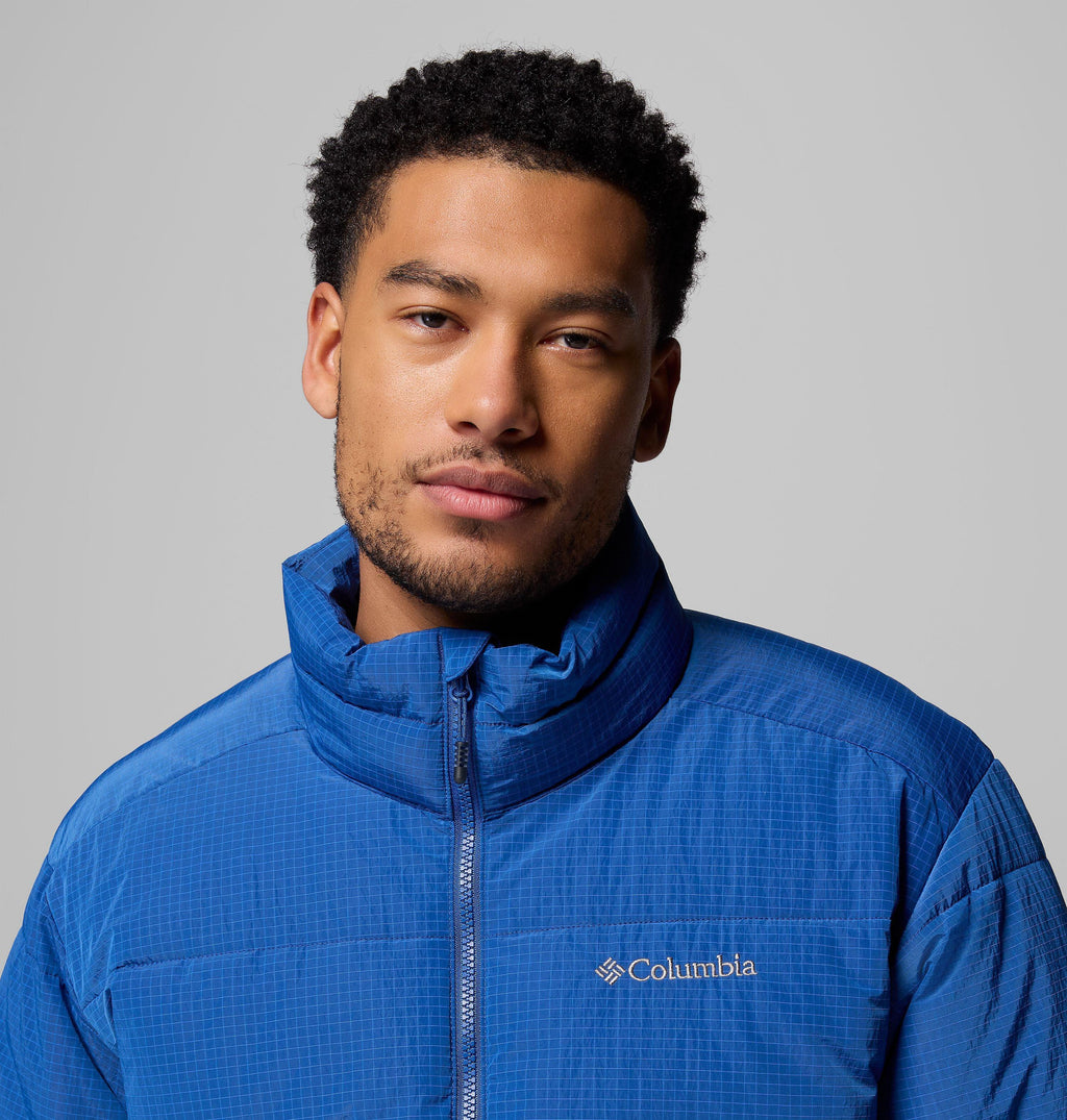 Men's blue puffer jacket with stand collar and Columbia logo on the chest.
